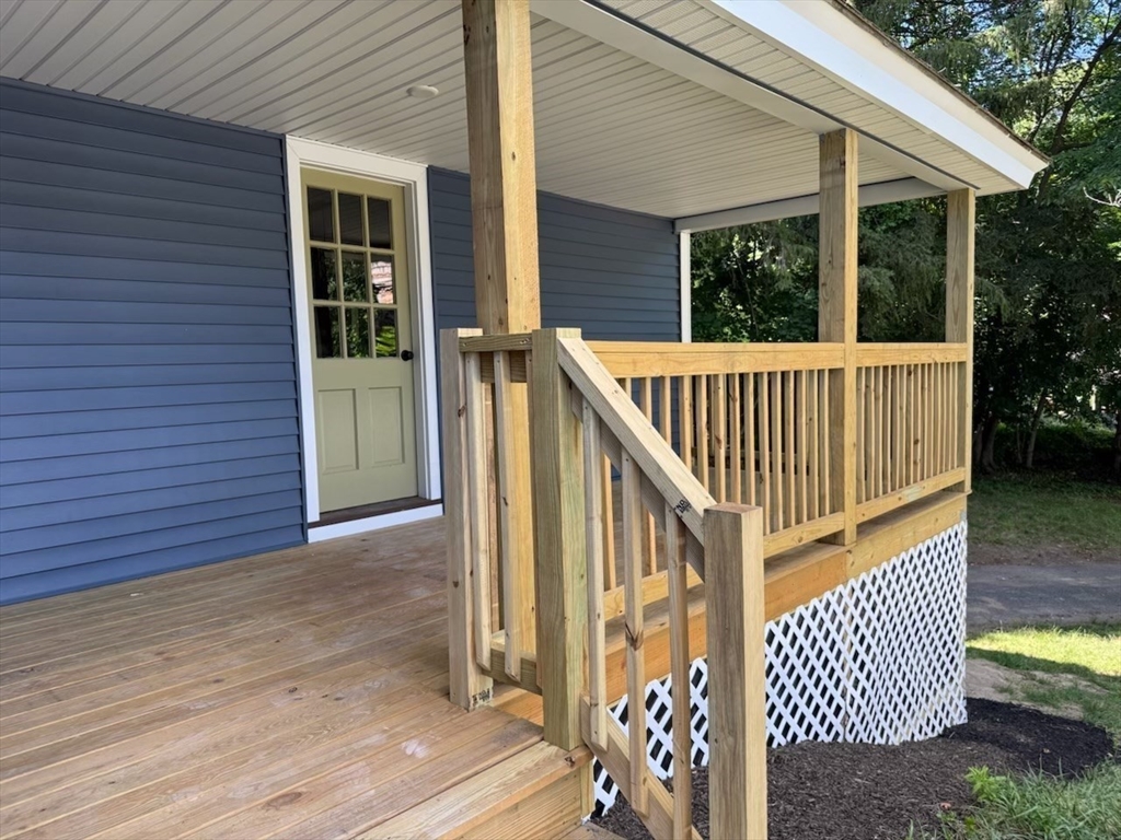 37 Bridge Street Monson, MA 01057 - Photo 21 of 35 an outdoor view of porch with wooden floor and chair
