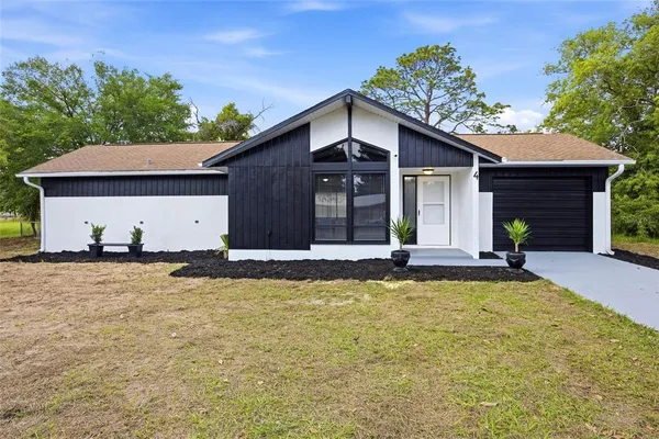 a view of a house with a yard and roof
