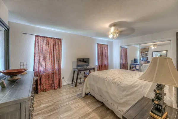 a bedroom with a bed and a chandelier