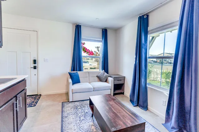 a view of a livingroom with workspace and a window