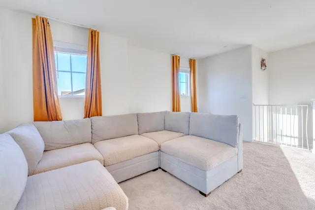 a view of a patio with a table and chairs under an umbrella