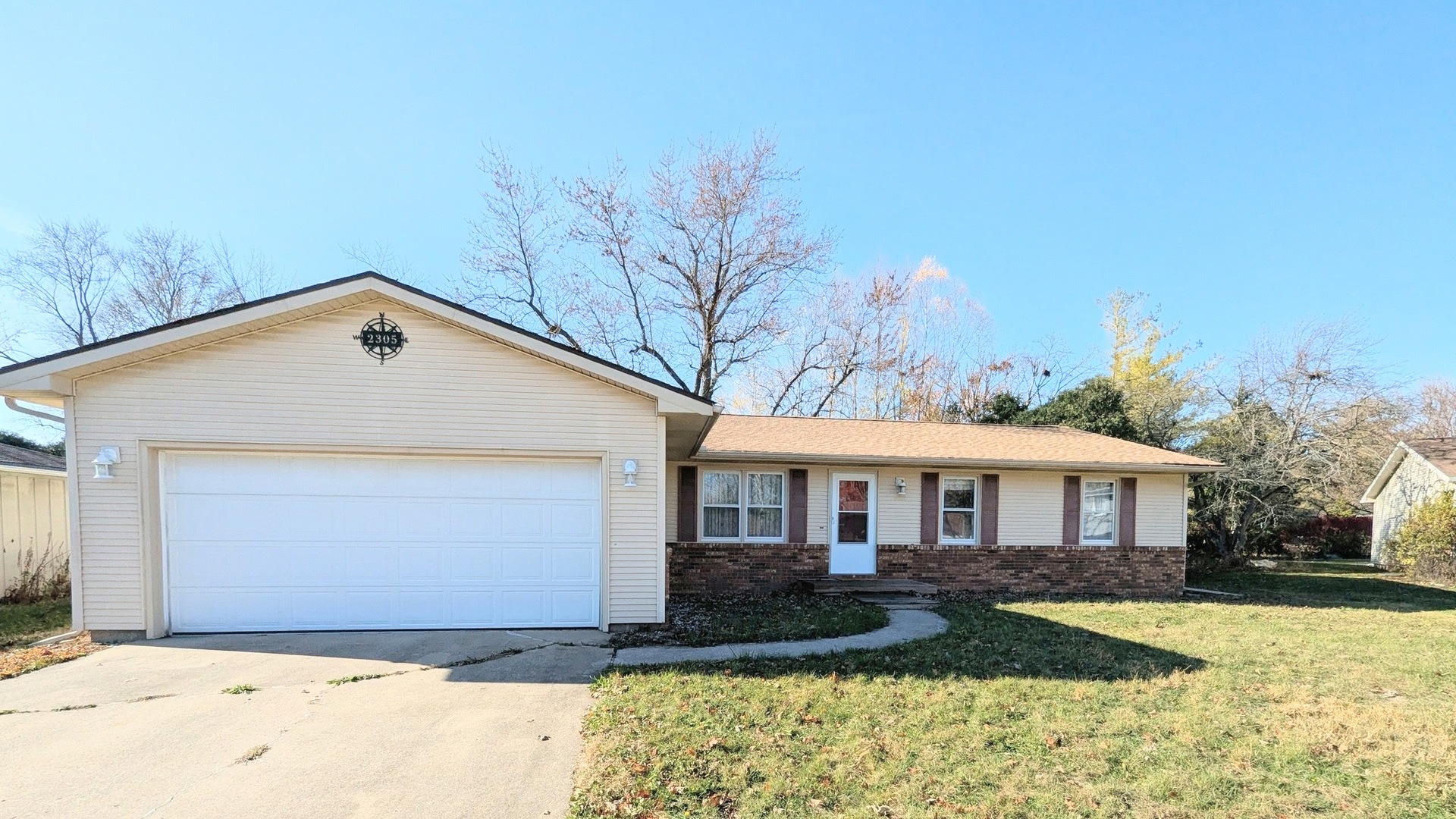 2305 East Shurts Circle Urbana, IL 61801 - Photo 1 of 26 a front view of a house with a yard