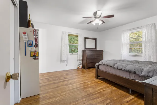 a spacious bedroom with a bed and a chandelier