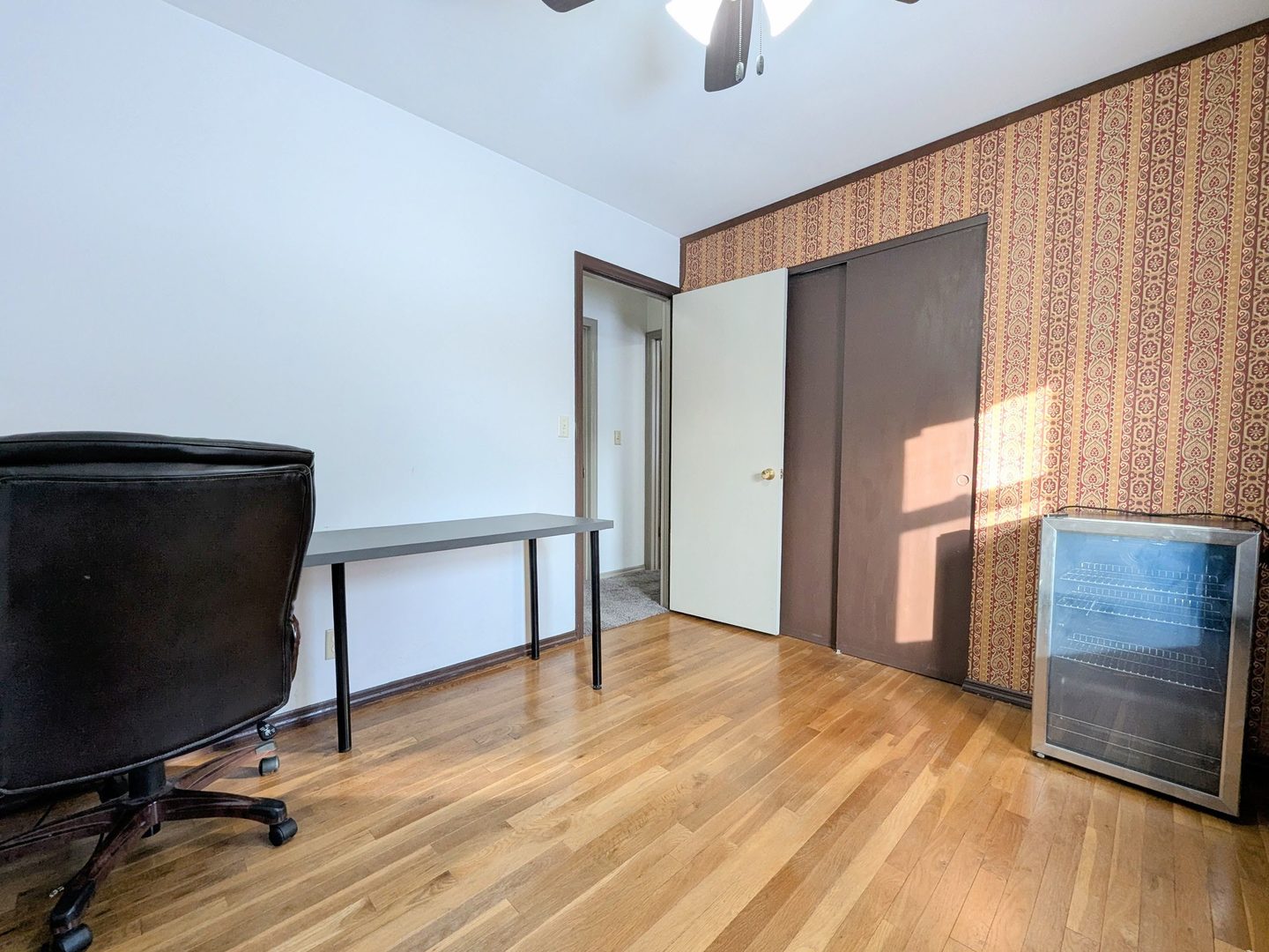 2305 East Shurts Circle Urbana, IL 61801 - Photo 19 of 26 a view of an empty room with a window and wooden floor