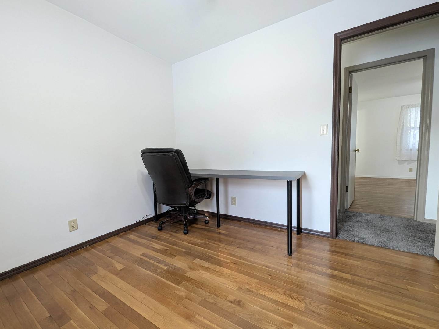 2305 East Shurts Circle Urbana, IL 61801 - Photo 20 of 26 a view of a workspace with wooden floor and a chair