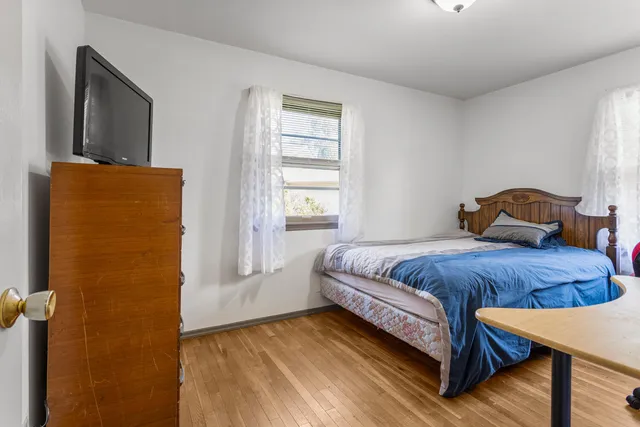 a bedroom with a bed and window