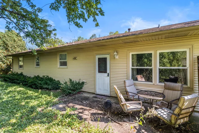 a view of a house with backyard and sitting area
