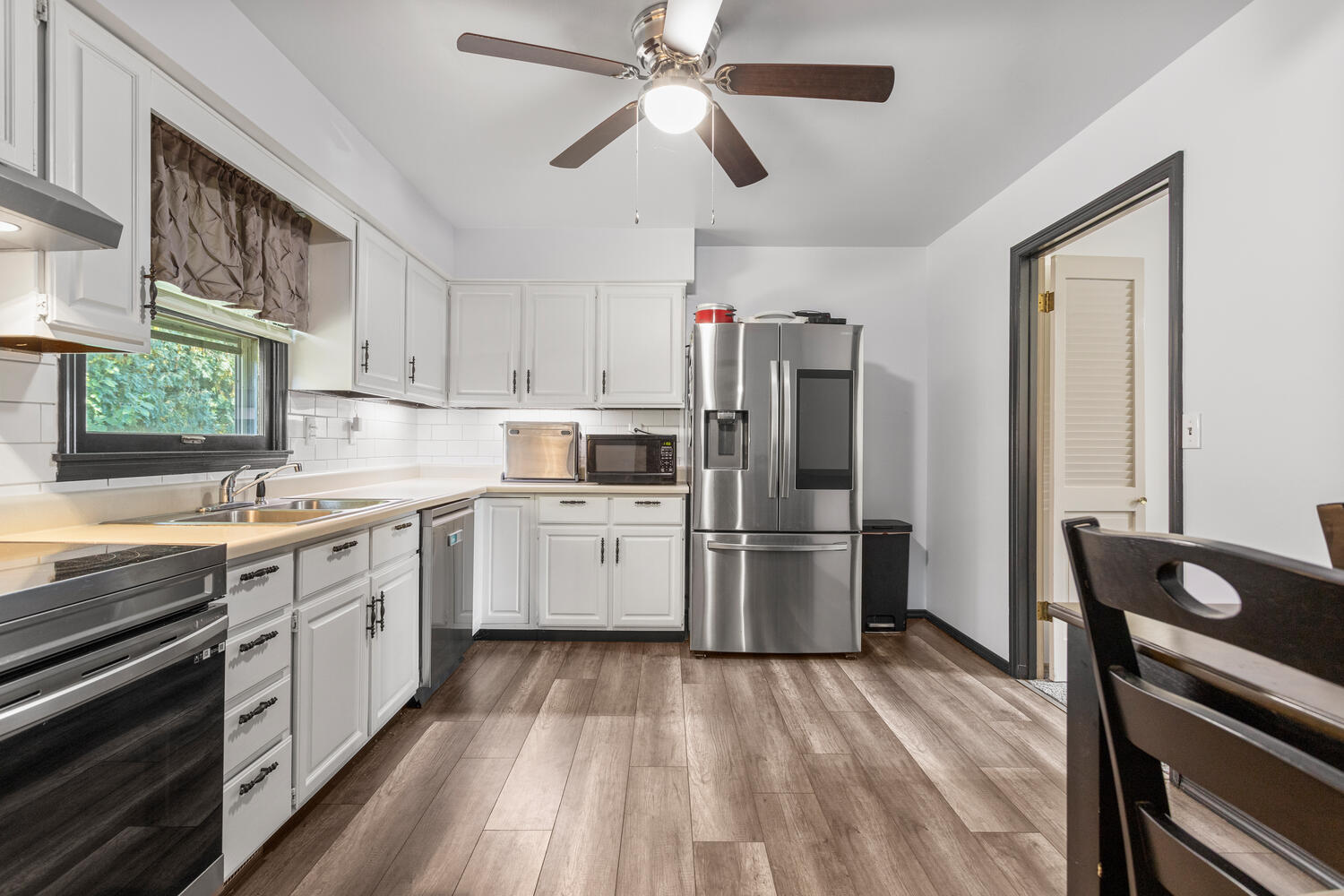 2305 East Shurts Circle Urbana, IL 61801 - Photo 7 of 26 a kitchen with a stove a sink and a refrigerator