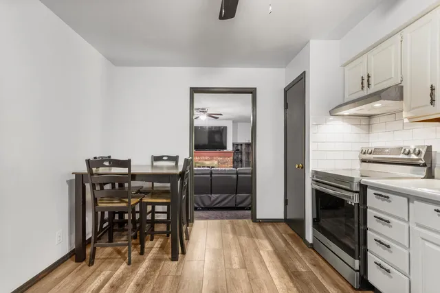 a kitchen with a table and chairs in it