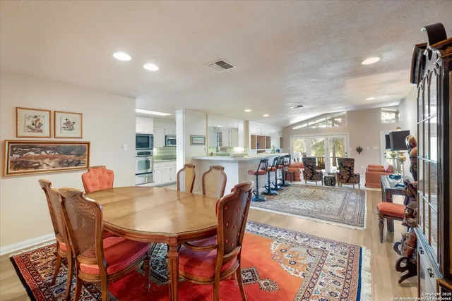 a dining room with furniture and wooden floor