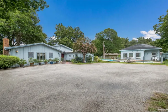a front view of house with yard and green space