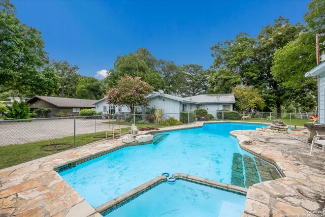 swimming pool view with a seating space