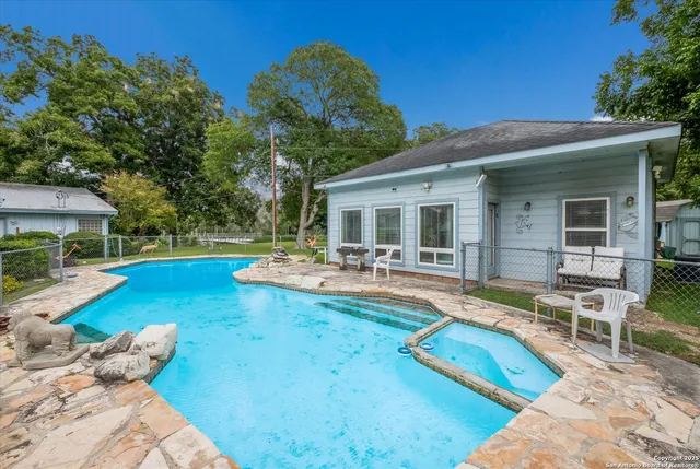 a view of a house with swimming pool and sitting area