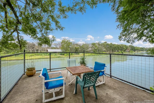 an outdoor sitting area with lake view