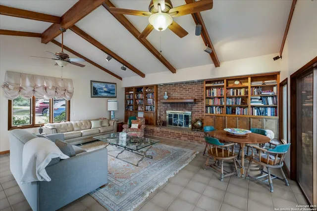 a living room with furniture and a book shelf