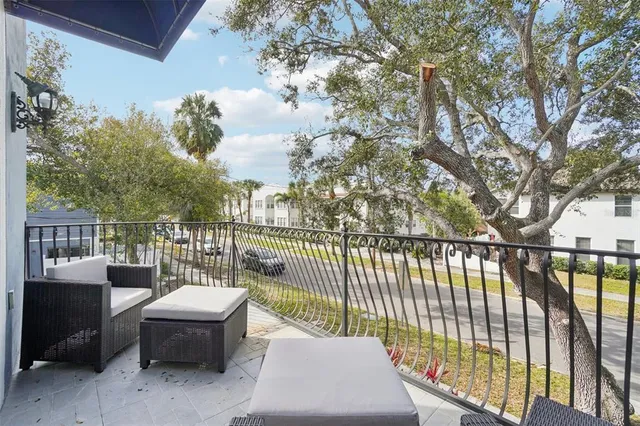 a view of a balcony with furniture