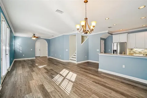 a view of a room with wooden floor and chandelier