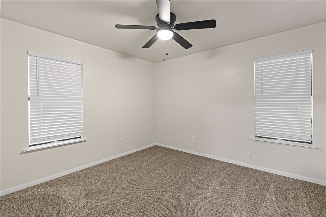 5921 Riley Drive Corpus Christi, TX 78412 - Photo 17 of 20 an empty room with a window and a ceiling fan