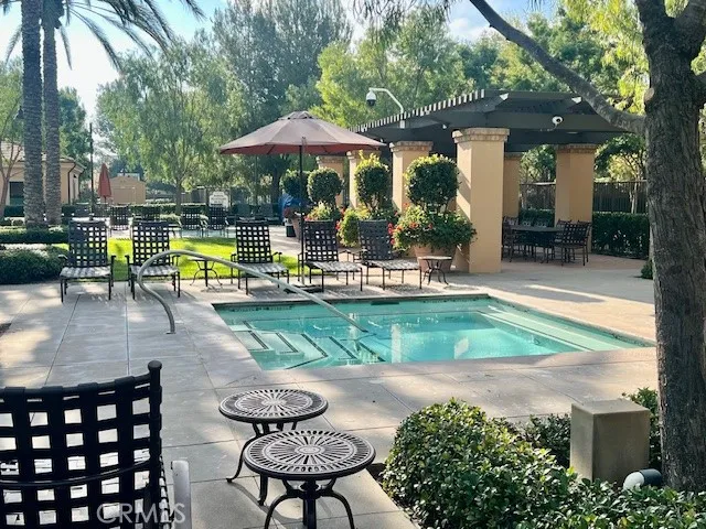 an outdoor space with patio and white umbrellas
