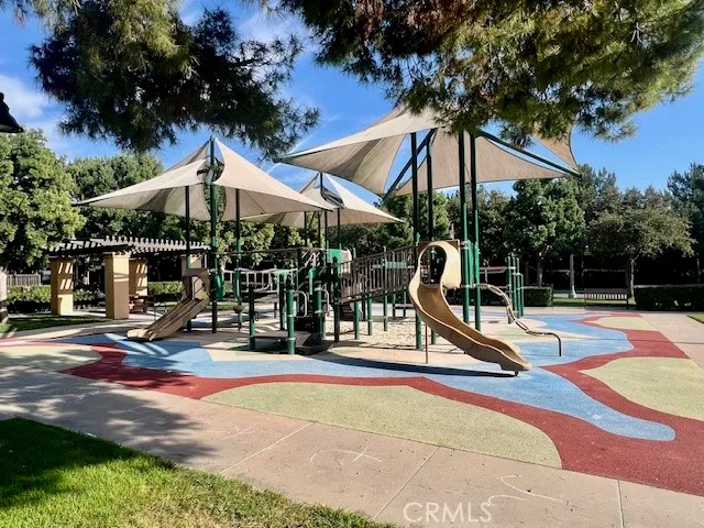 a view of outdoor space with playground and green space