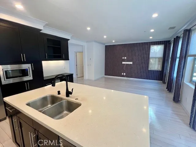 a kitchen with a sink and a refrigerator