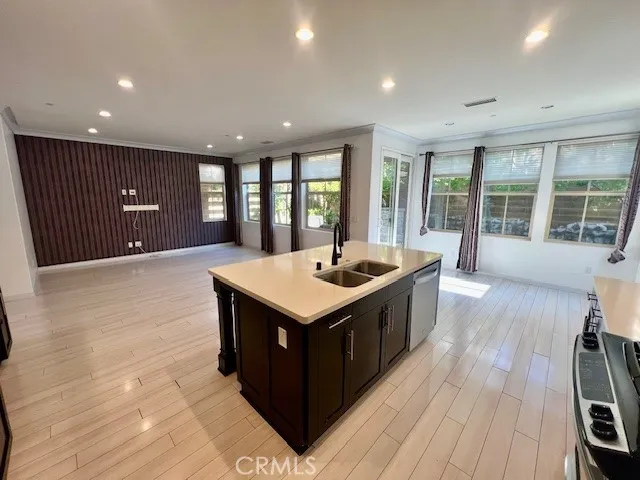 a kitchen with stainless steel appliances granite countertop a stove and a large window