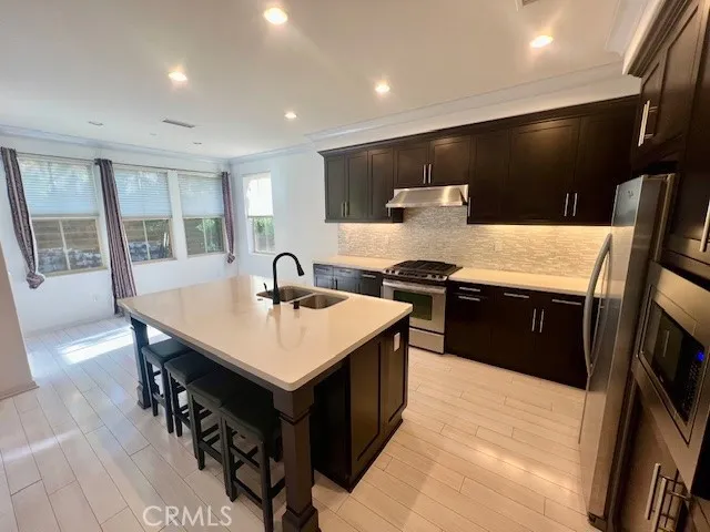 a kitchen with a stove a refrigerator and a sink