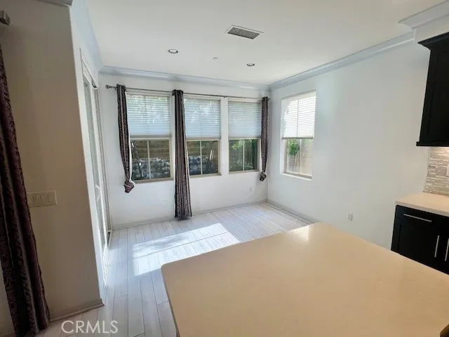 a view of a room with window and hardwood floor