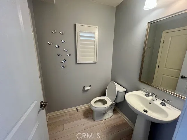 a bathroom with a sink toilet and a mirror