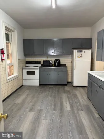 a kitchen with a stove and a refrigerator
