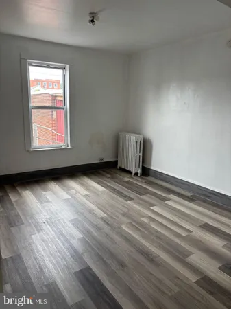 a view of a room with wooden floor and closet