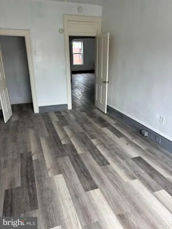 a view of a room with wooden floor and closet