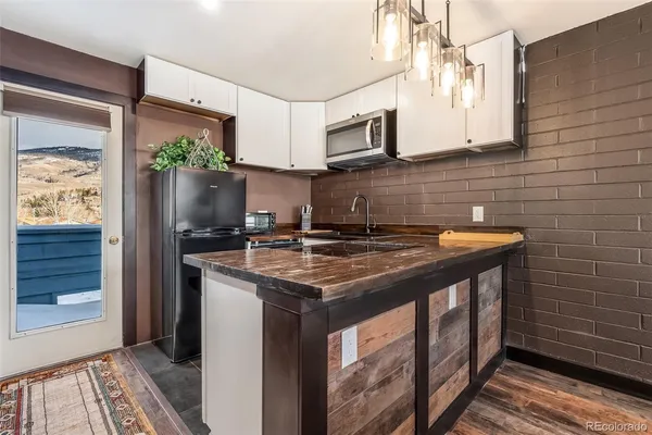 a kitchen with stainless steel appliances a sink stove and cabinets