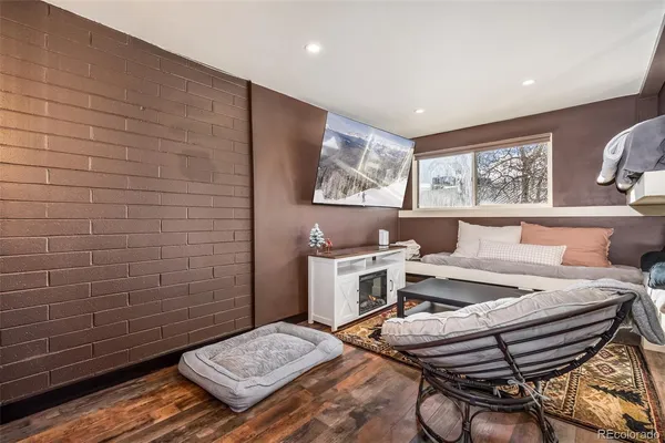 a bed room with a bed and paintings on the wall