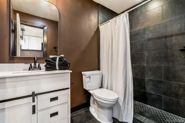 a bathroom with a toilet a sink and a mirror