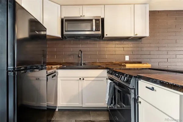 a kitchen with a stove microwave and sink