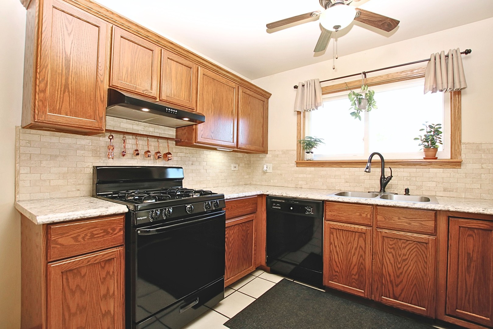 1151 Sandpebble Circle Algonquin, IL 60102 - Photo 12 of 34 a kitchen with stainless steel appliances granite countertop a sink stove and cabinets
