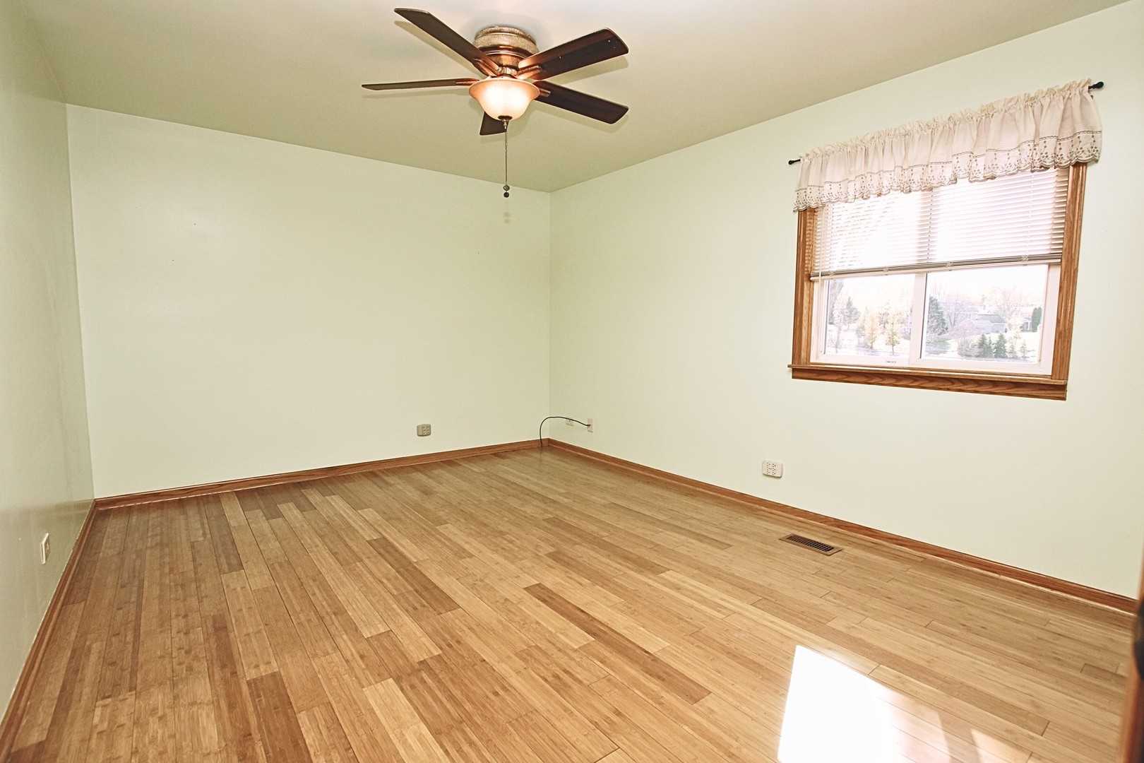 1151 Sandpebble Circle Algonquin, IL 60102 - Photo 16 of 34 a view of an empty room with wooden floor and a window