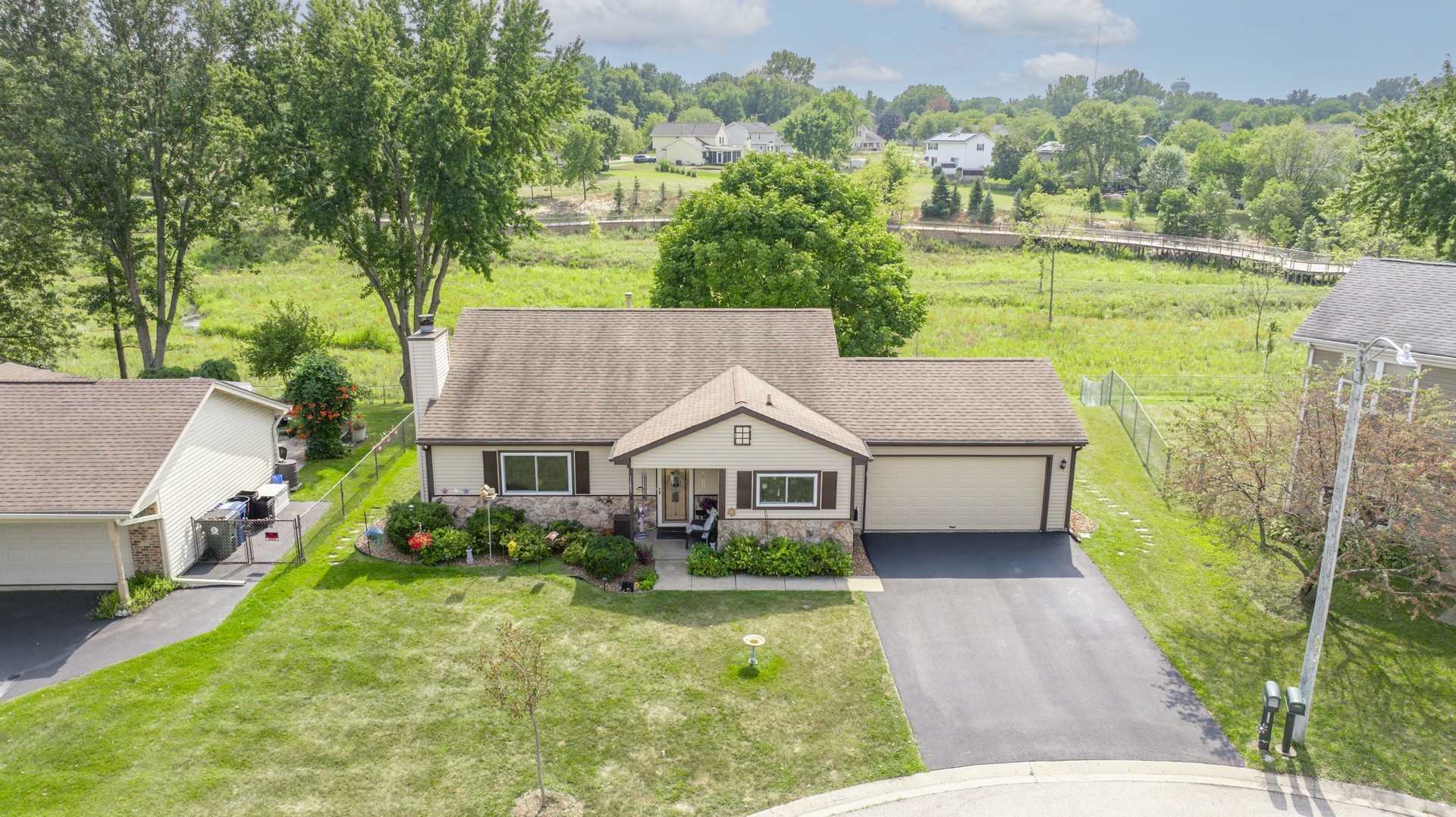 1151 Sandpebble Circle Algonquin, IL 60102 - Photo 2 of 34 a aerial view of a house next to a big yard and large trees