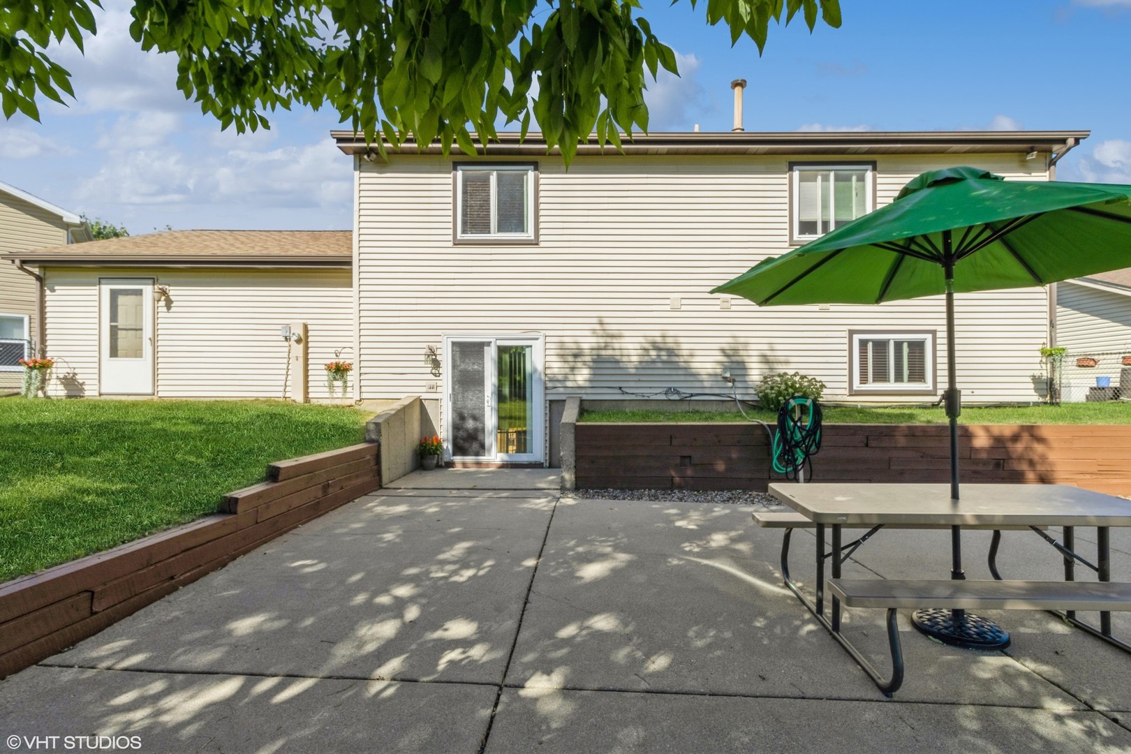 1151 Sandpebble Circle Algonquin, IL 60102 - Photo 24 of 34 a patio with a table and chairs under an umbrella