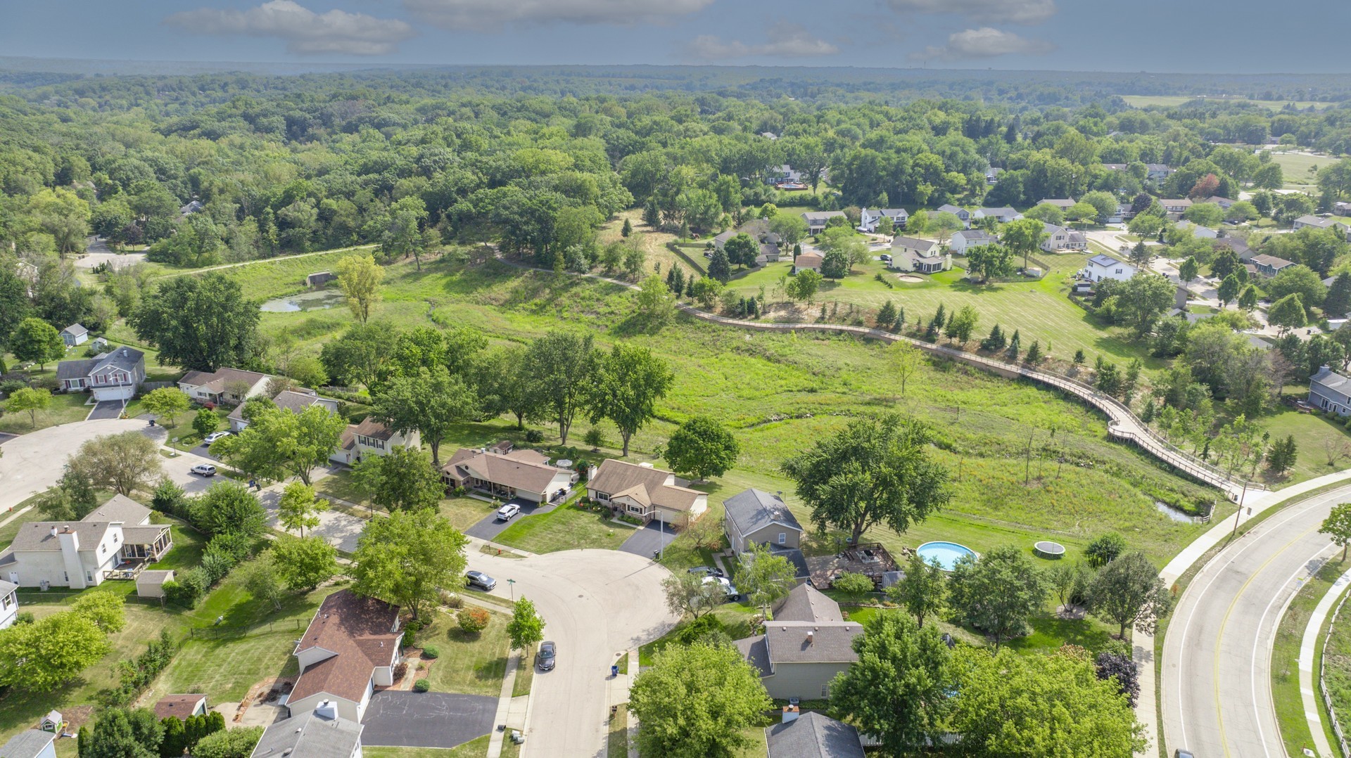1151 Sandpebble Circle Algonquin, IL 60102 - Photo 7 of 34 a view of a garden with a lake