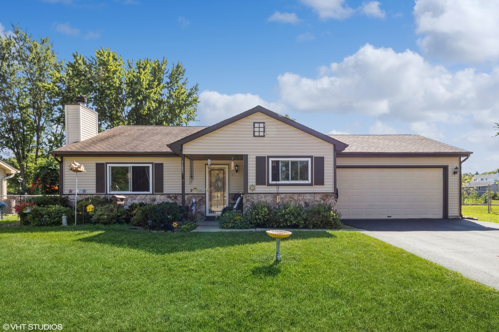 1151 Sandpebble Circle Algonquin, IL 60102 - Photo 8 of 34 a front view of a house with a garden and yard
