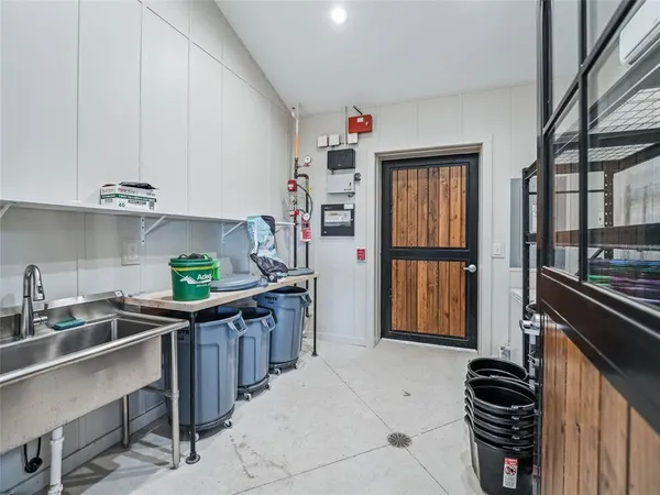a kitchen with stainless steel appliances a sink cabinets and wooden floor