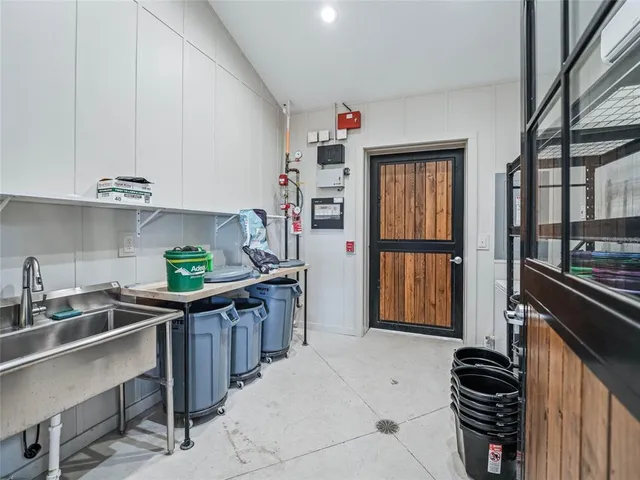 a kitchen with stainless steel appliances a sink cabinets and wooden floor