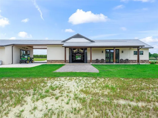 a view of a house with a yard and sitting area