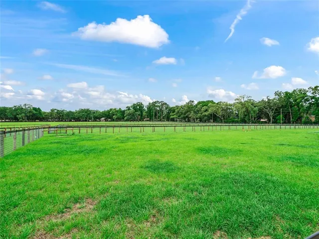 a view of swimming pool with outdoor seating and yard in back