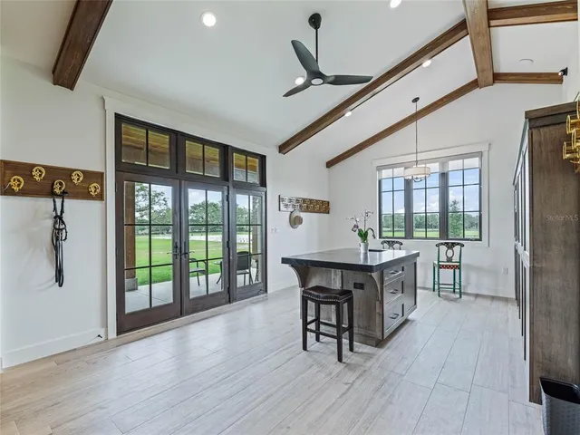 a view of a swimming pool with a table and chairs in the patio