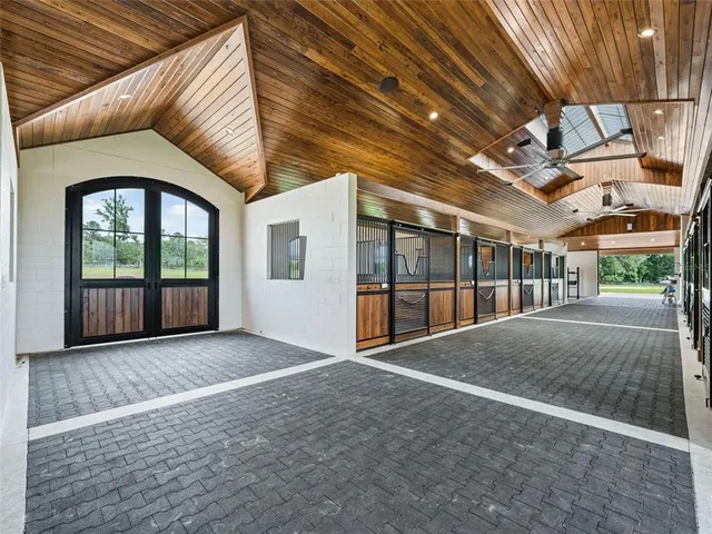 a kitchen with granite countertop a sink stainless steel appliances and white cabinets