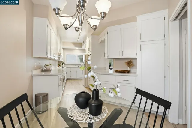 a kitchen with stainless steel appliances granite countertop a sink a stove and a wooden floors