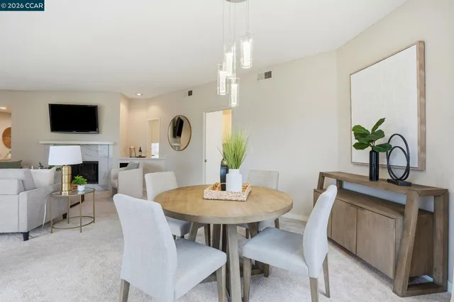 a view of a dining room with furniture and a fireplace